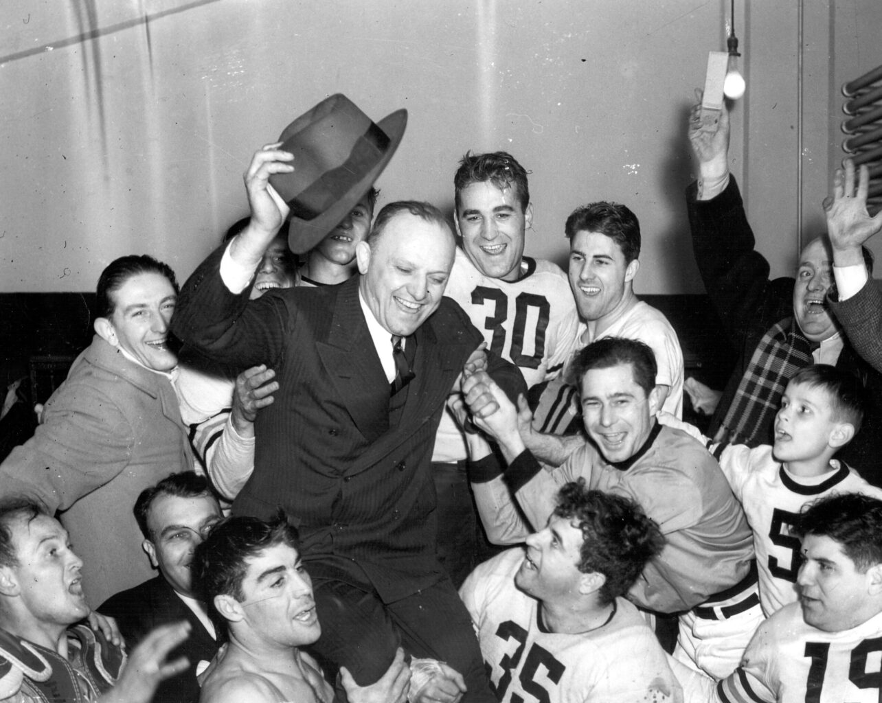 Bears owner and coach George Halas is hoisted on shoulders of players in the dressing room after the team beat the Washington Redskins 73-0 in the 1940 NFL Championship game. Photo credit: Pro Football Hall of Fame